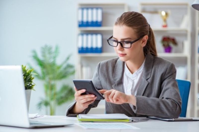 accounting-services-woman-glasses-holding-calculator-min