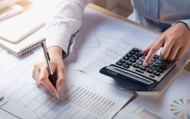 accounting-services-In-small-business-south-africa-finance-and-accounting-concept-business-woman-working-on-desk-using-calculator-to-calculate-min