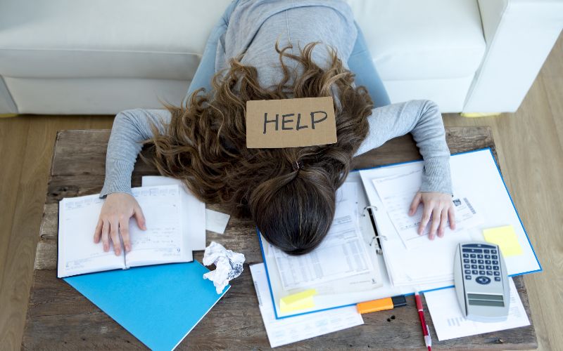 SureBooks- accounting services for small bsuyoung-woman-asking-for-help-suffering-stress-doing-domestic-accounting-paperwork-bills-min