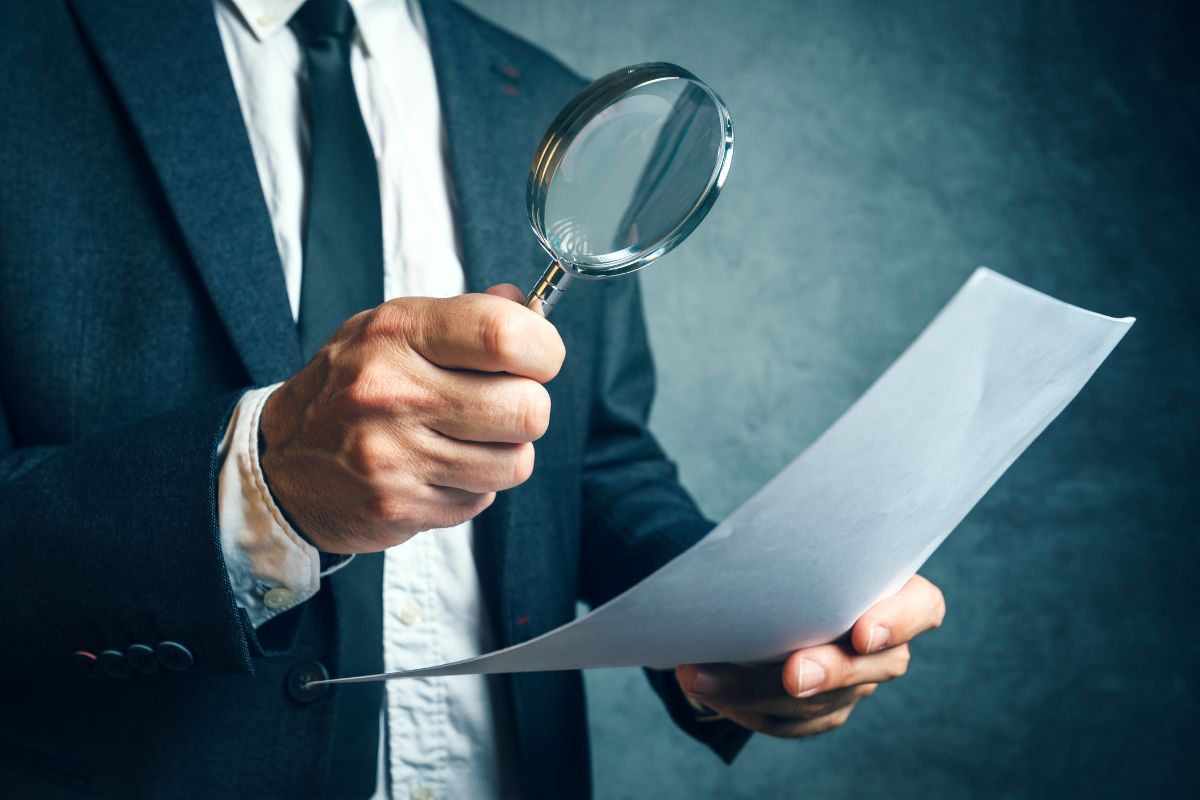 Accounting Services For Small Business South Africa -tax-inspector-investigating-financial-documents-through-magnifying-glass-min