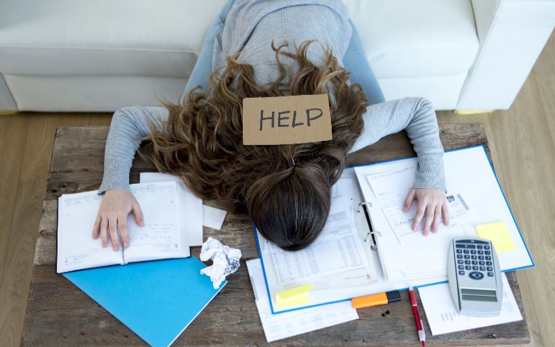 SureBooks- accounting services for small bsuyoung-woman-asking-for-help-suffering-stress-doing-domestic-accounting-paperwork-bills-min
