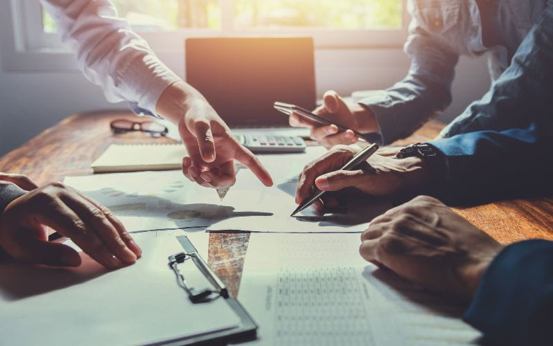 SureBooks - Accounting Services Capbusiness-accounting-team-meeting-in-room-office-using-pen-pointing-at-paperwork-finance-concept-060273265835 (1)