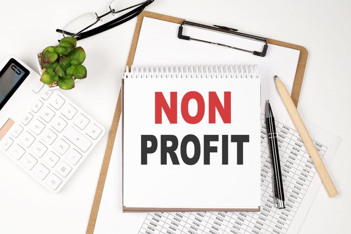 accounting-services-cape-town-office-desk-table-with-paper-sheet-notepad-chart-and-calculator-top-view-non-profit