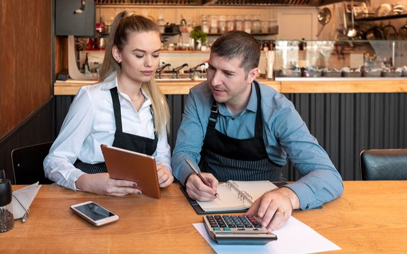 SureBooks - Accounting Services For Small Busienss South Africa - man and woman doing accounting in cafe (1)